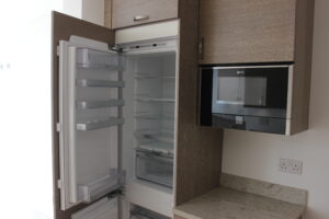 Modern built-in German kitchen in Harrow with integrated fridge and microwave